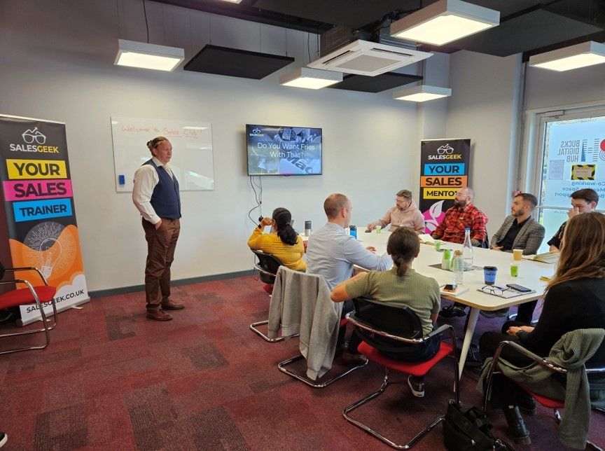 Group of people seated around the table attending a workshop