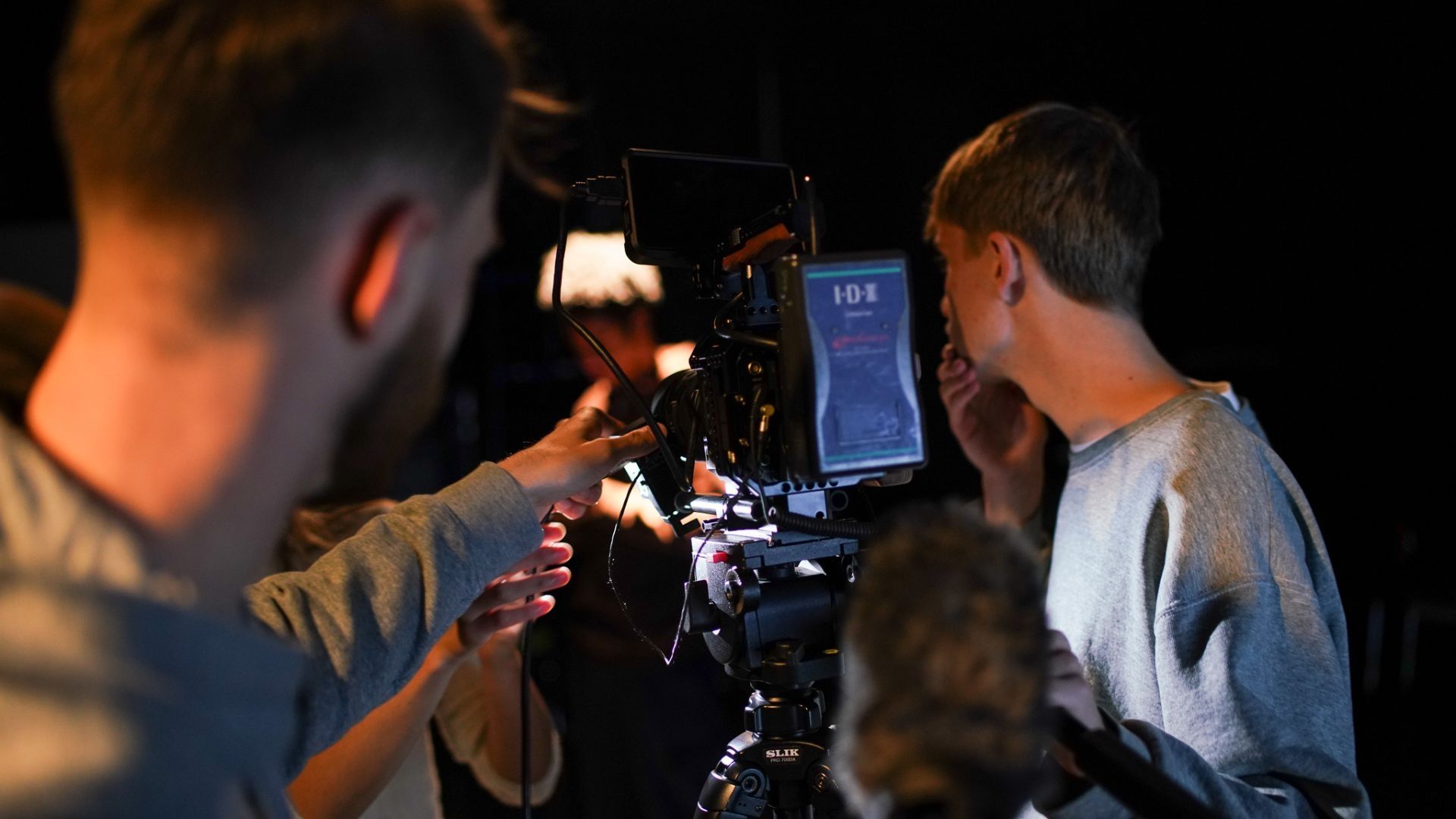 Two students looking through a camera on a tripod