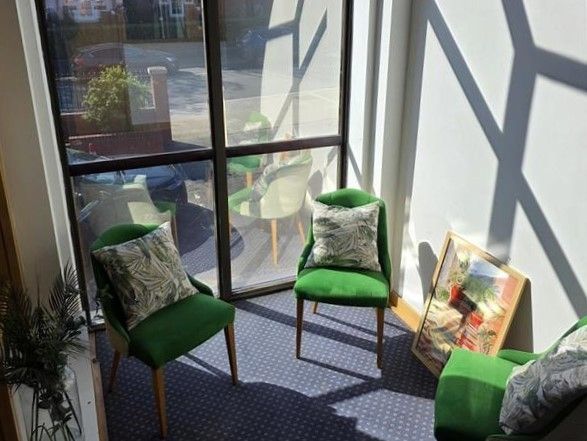 Picture of communal lounge at Alex House with chairs and cushions