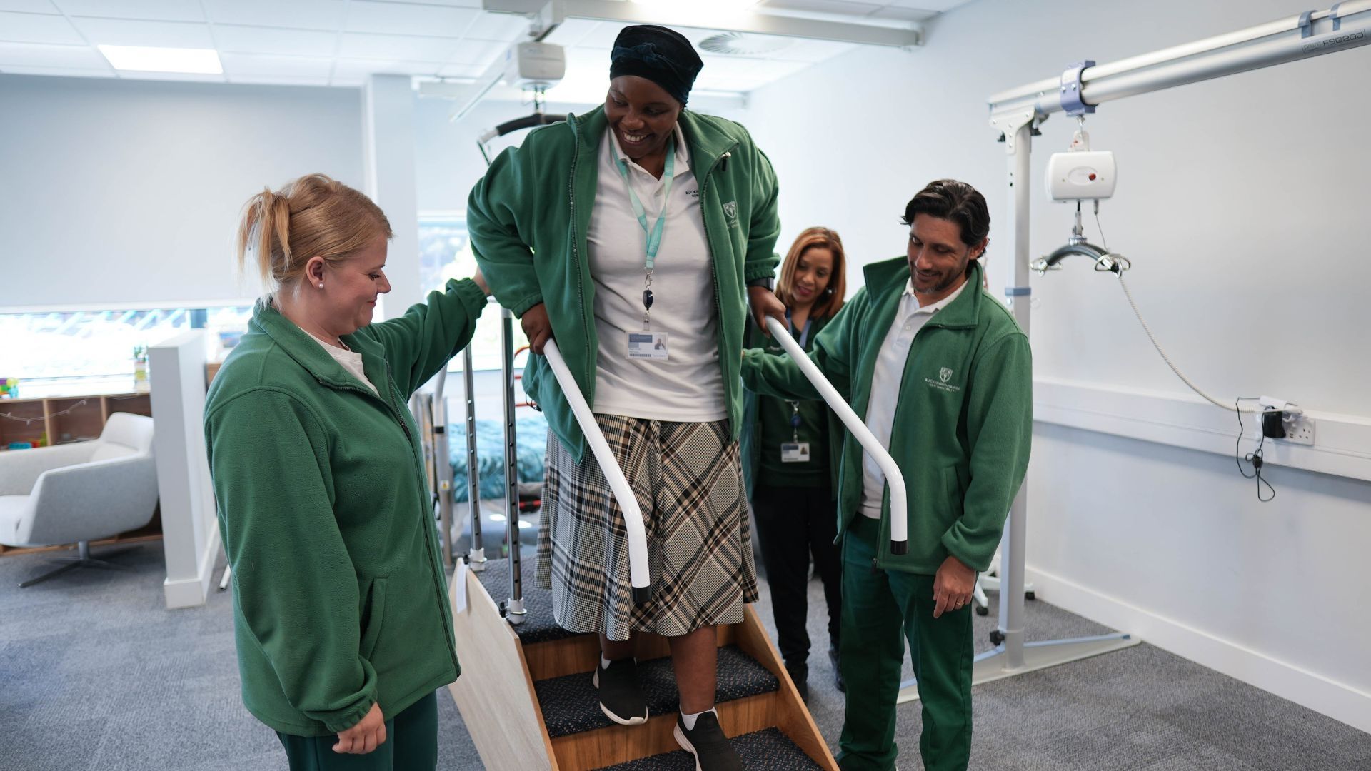 An Occupational Therapy student walking down some stairs in a classroom setting.