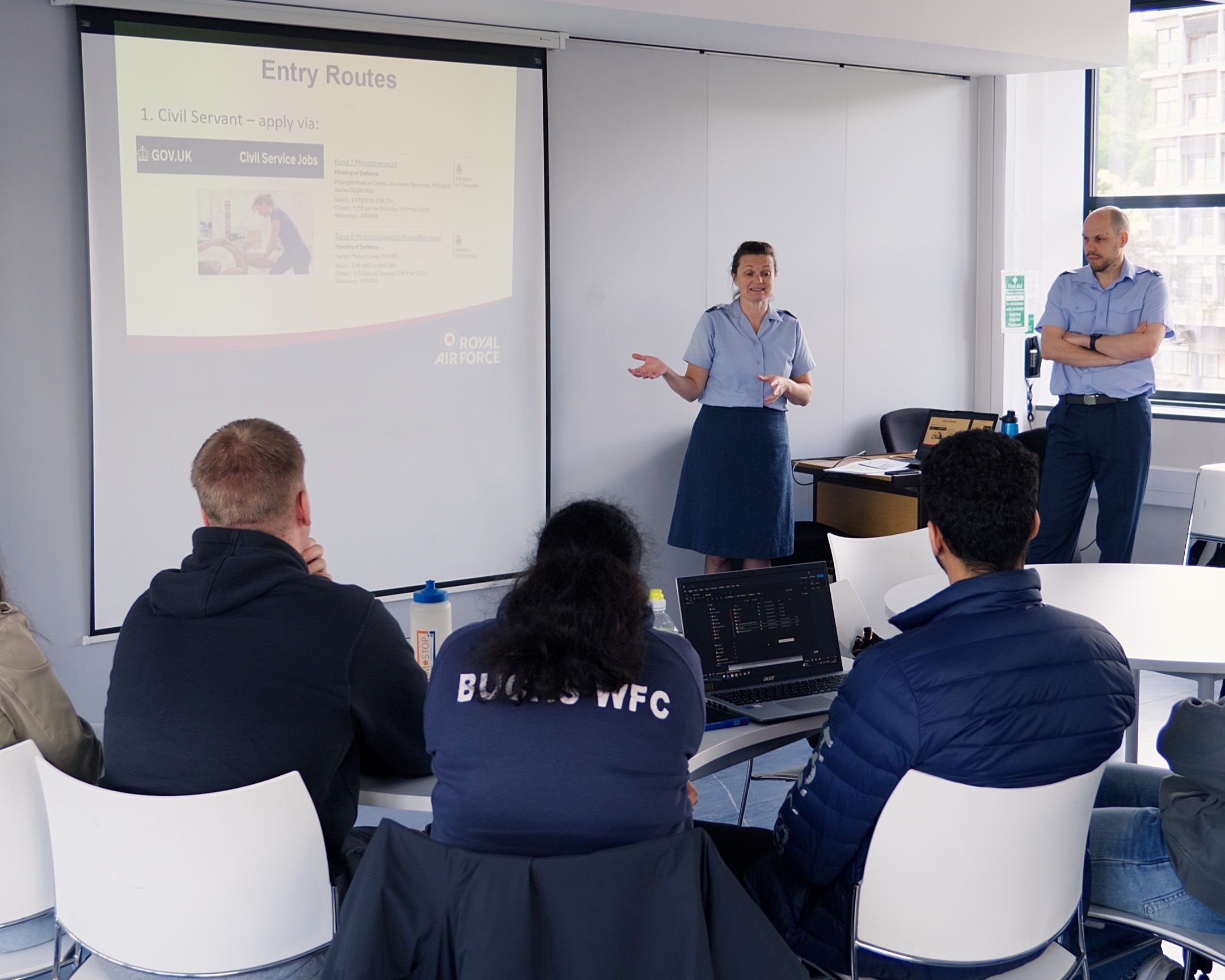 Royal Air Force medical services delivering a presentation to a group of students.